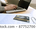 Woman picking credit card in wallet for shopping online. 87752700