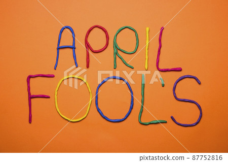 Funny font first april fools day written in plastecine of different colors. 87752816