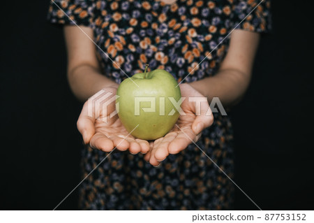 green apple in hands of woman green apple in hands of woman 87753152