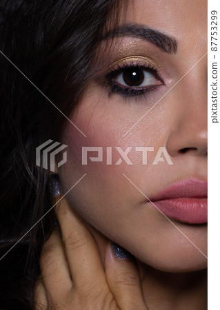 Half close-up of beauty girl with long straight developing hair and radiant eveningtime makeup on her face. Skin care natural cosmetics in the spa salon or cosmetology. Half close-up of beauty girl with long straight developing hair and radiant eveningtime makeup on her face. Skin care natural cosmetics in the spa salon or cosmetology. 87753299