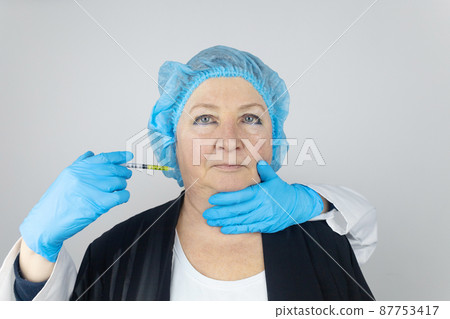 Botulinum toxin injection. Senior woman at the appointment with a beautician who is preparing to give anti-wrinkle injections. Loose skin and hypotension. Mimic wrinkles and contouring 87753417