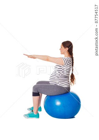 Pregnant woman doing exercises with exercise ball Pregnant woman doing exercises with exercise ball 87754517