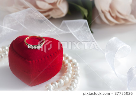 Ring with diamonds in a red case. Ring with diamonds in a red case. 87755026