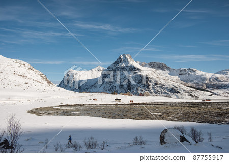 Snowy mountain range on coastline in winter on sunny day at Lofoten islands 87755917