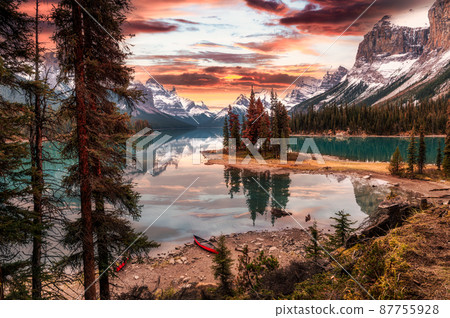 Beautiful view of Spirit island with canoe and dramatic sky on autumn season in the sunset at Jasper national park Beautiful view of Spirit island with canoe and dramatic sky on autumn season in the sunset at Jasper national park 87755928