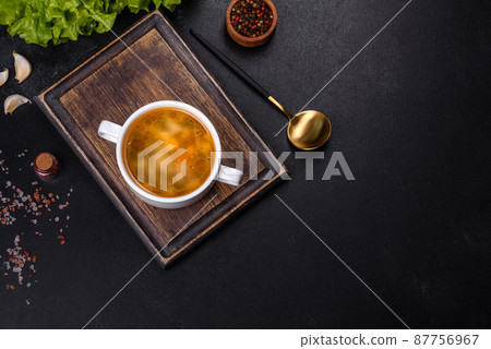 Chicken noodle soup with parsley and vegetables in a white plate Chicken noodle soup with parsley and vegetables in a white plate 87756967