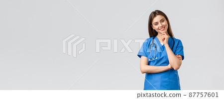 Medical workers, healthcare, covid-19 and vaccination concept. Upbeat smiling pretty nurse, doctor in blue scrubs, working clinic, looking with enthusiastic gaze camera, listening to coworker 87757601
