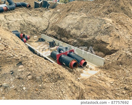 construction of a drainage system in residential buildings. wide black pipes on a concrete gray foundation. laying sewers 87757692