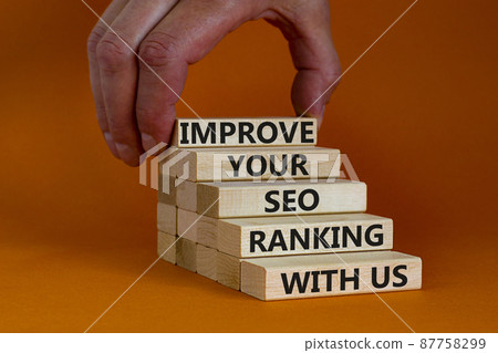 Improve your SEO ranking with us symbol. Wooden blocks with words Improve your SEO ranking with us. Businessman hand. Beautiful orange background, copy space. Business, improve SEO ranking concept. 87758299