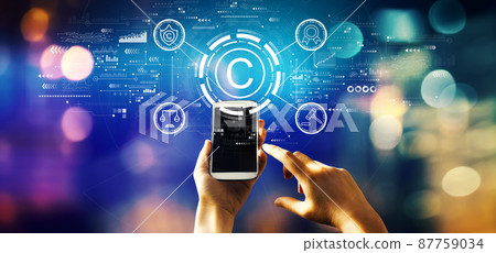 Copyright concept with person using a phone Copyright concept with person using a phone 87759034