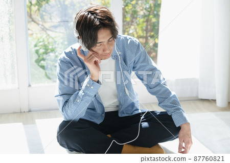 Young man listening to music Young man listening to music 87760821