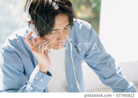 Young man listening to music Young man listening to music 87760822