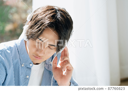 Young man listening to music Young man listening to music 87760823