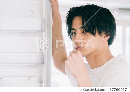 A young man brushing a tooth A young man brushing a tooth 87760937