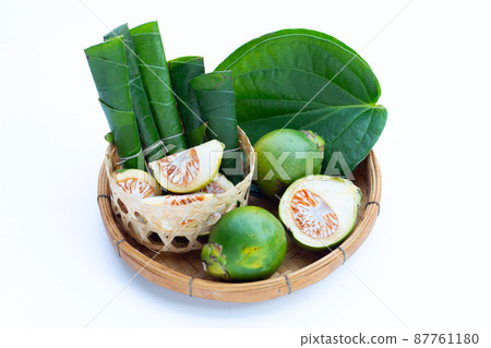 Chewing betel nut, Betel nut with cal lime powder on betel leaves 87761180