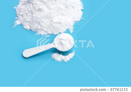 Baking soda on blue background. Baking soda on blue background. 87761215