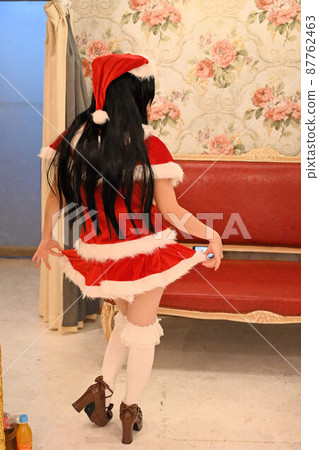 Back view of a woman in Santa Claus costume Back view of a woman in Santa Claus costume 87762463