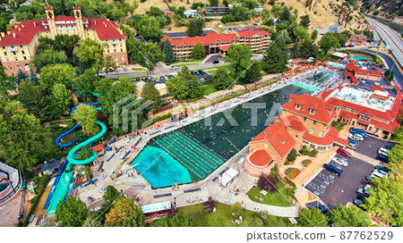 Aerial of beautiful blue natural hot springs attraction in desert town 87762529