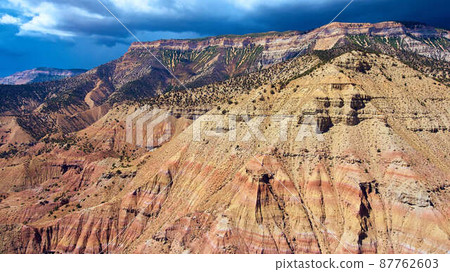 Giant desert sandy mountains with spotted green plants Giant desert sandy mountains with spotted green plants 87762603