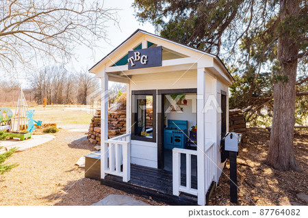 Sunny view of a wooden house in The Botanic Garden of Oklahoma State University 87764082
