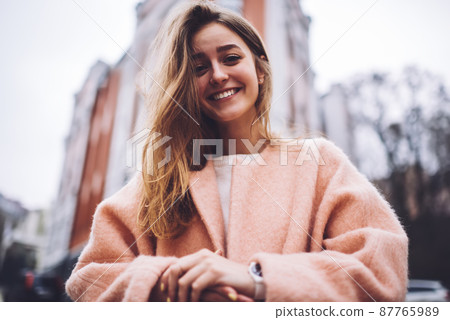 Cheerful female with clasped hands on street Cheerful female with clasped hands on street 87765989