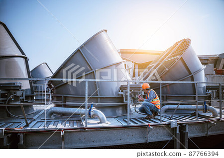 Industry engineer under checking the industry cooling tower air conditioner is water cooling tower air chiller HVAC of large industrial building to control air system Industry engineer under checking the industry cooling tower air conditioner is water cooling tower air chiller HVAC of large industrial building to control air system 87766394
