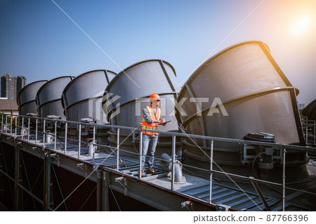 Industry engineer under checking the industry cooling tower air conditioner is water cooling tower air chiller HVAC of large industrial building to control air system Industry engineer under checking the industry cooling tower air conditioner is water cooling tower air chiller HVAC of large industrial building to control air system 87766396