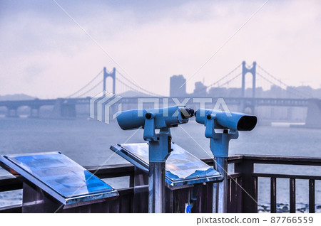 Coin-operated binoculars. Binocular telescope on the observation deck for tourism. Coin-operated binoculars. Binocular telescope on the observation deck for tourism. 87766559