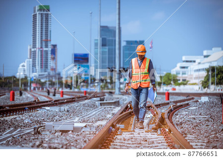 Engineer under discussion inspection and checking construction process railway switch and checking work on railroad station .Engineer wearing safety uniform and safety helmet in work. Engineer under discussion inspection and checking construction process railway switch and checking work on railroad station .Engineer wearing safety uniform and safety helmet in work. 87766651