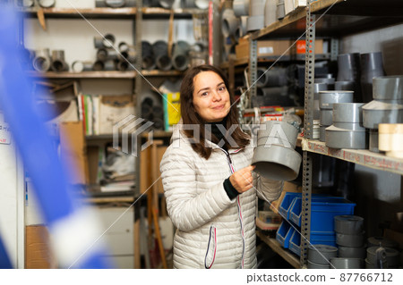 Brunette looking for plumbing fittings in construction hypermarket 87766712