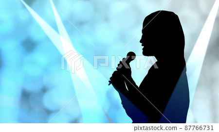 Female silhouette and spotlight singing with a microphone 87766731