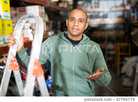 Confident Hispanic man owner of building materials store Confident Hispanic man owner of building materials store 87766779