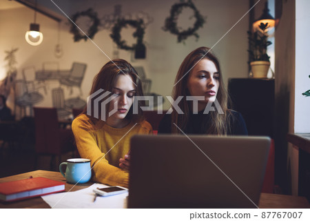 Executive women working in modern cafe 87767007