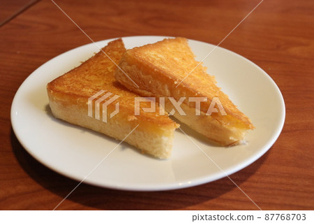 Triangle toasted bread on dish. Triangle toasted bread on dish. 87768703