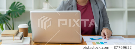 Business analyst concept the data analyst holding and pointing her pen at the document about sale chart Business analyst concept the data analyst holding and pointing her pen at the document about sale chart 87769632