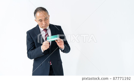 A businessman who is worried about looking at his passbook 87771192