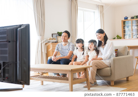 Young family watching tv Young family watching tv 87771463