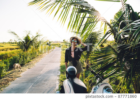 Hipster girl posing at tropical environment 87771860