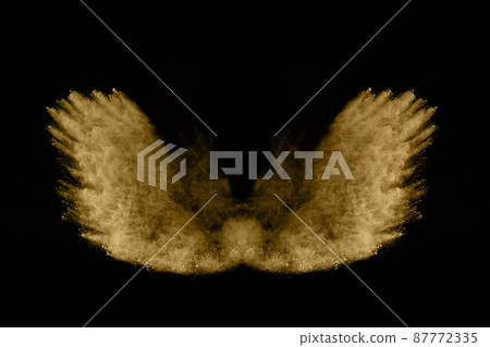 Golden powder explosion on black background. Freeze motion. Golden powder explosion on black background. Freeze motion. 87772335