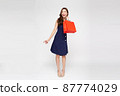 Asian woman holding shopping bags in full body isolated on white background, Shopper or shopaholic concept 87774029