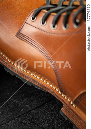 Closeup on handcrafted brown leather boots  Closeup on handcrafted brown leather boots  87774210