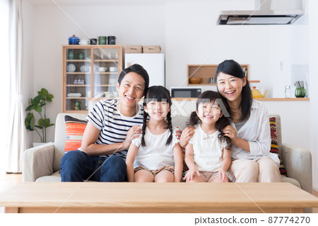 Young family relaxing in the living room 87774270