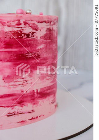 Side view of colorful pink birthday cake. Party celebration concept Modern stylish sweet cake Side view of colorful pink birthday cake. Party celebration concept Modern stylish sweet cake 87775091
