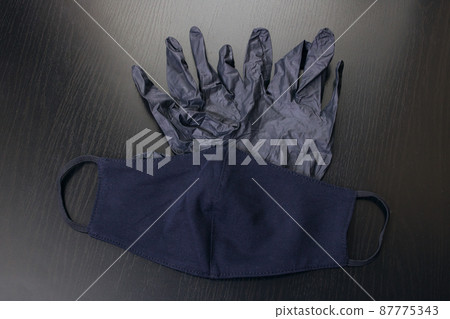 Black gloves and a medical mask closeup Black gloves and a medical mask closeup 87775343