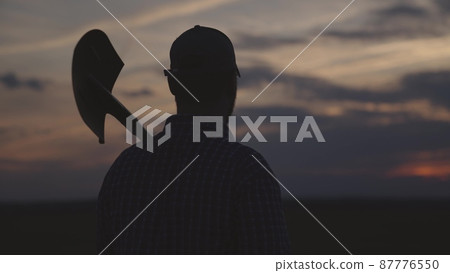 silhouette of farmer with shovel field, agriculture, gardening business spring work, summer sunset on rural land, harvest time, man gardener goes dig land on plantation, work soil farm agronomist 87776550