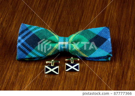 Tartan Bow Tie and Scottish Saltire Cuff Links on a Wooden Table 87777366