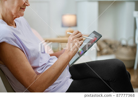 female designer with a tablet working on a new project. 87777368