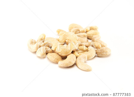 Pile of cashew nuts isolated on white background 87777383