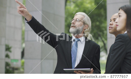caucasian businessman pointing upward with finger caucasian businessman pointing upward with finger 87777937