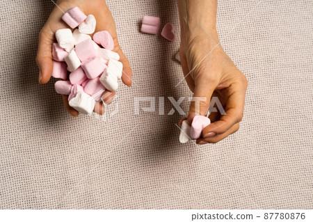 The kid takes the marshmallow hearts from his grandmother's hands. The concept of charity, assistance and relationships lay flat. The kid takes the marshmallow hearts from his grandmother's hands. The concept of charity, assistance and relationships lay flat. 87780876